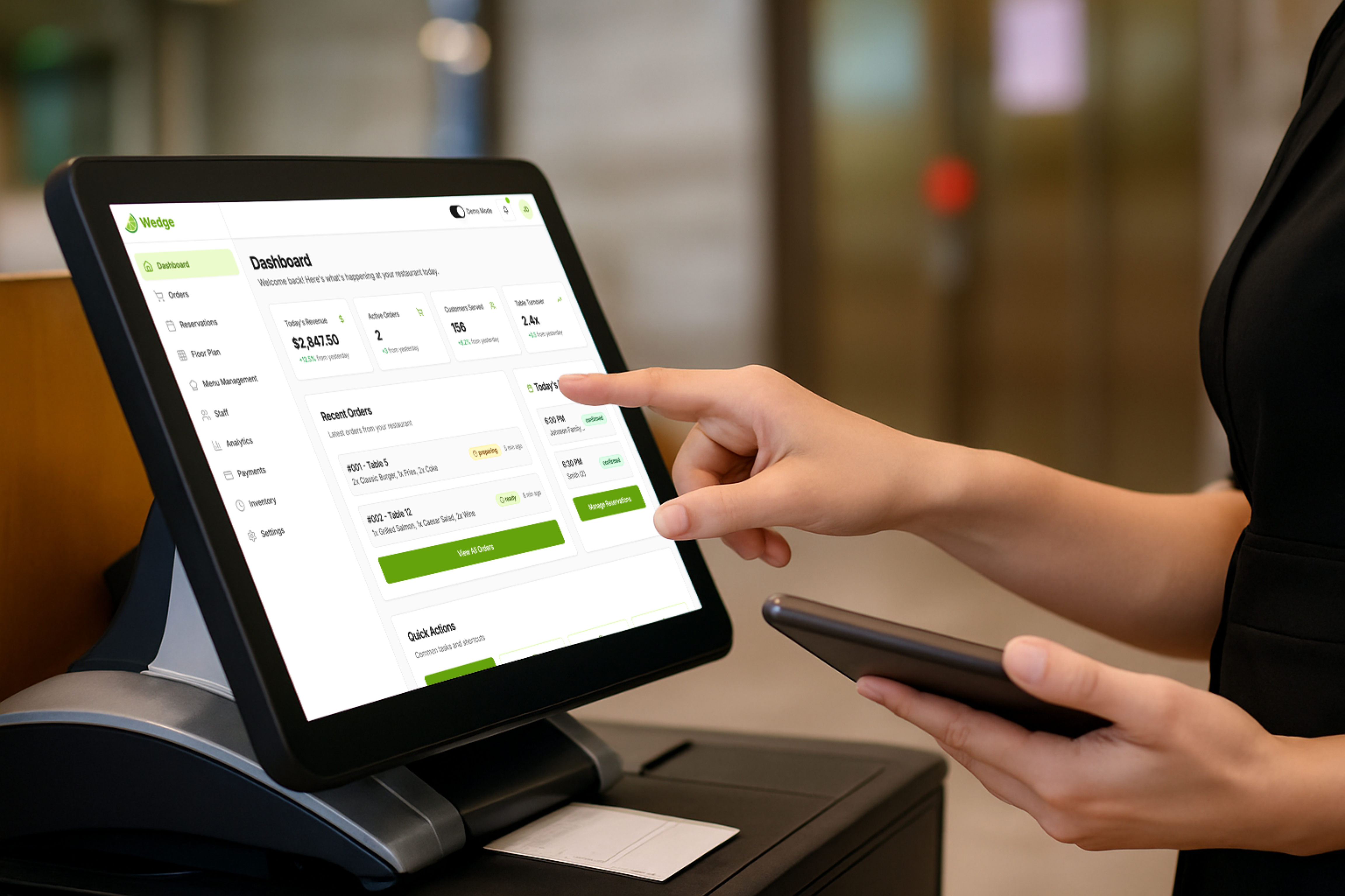 Cashier using POS system at a restaurant counter